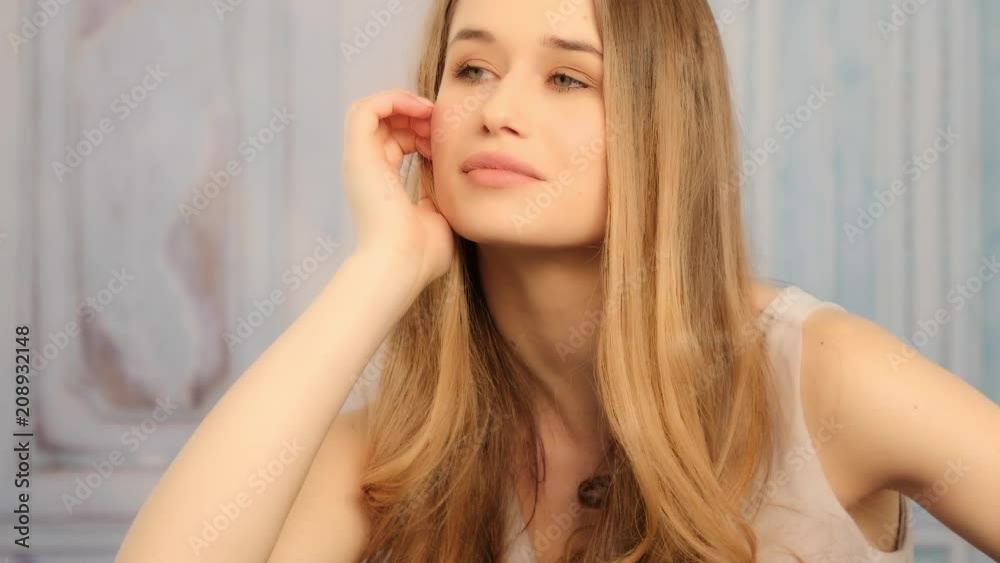 beautiful blonde woman with natural look posing in her house