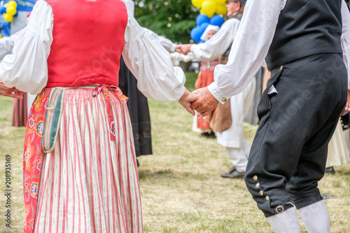 Unrecognizable people perform Swedish folk dance during National day celebration in Norrkoping