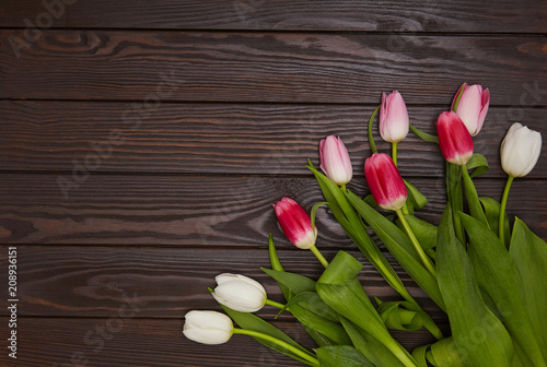 Tulips on a brown wooden background. Celebrstion and greeting concept. Space for text