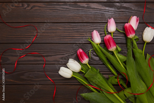 Tulips on a brown wooden background. Celebrstion and greeting concept. Space for text photo