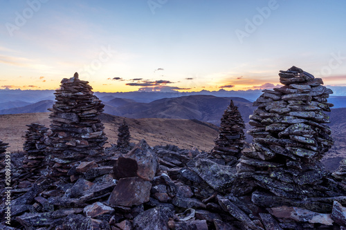 stack of balance stone on top of mountain with sunrsie in tibet photo