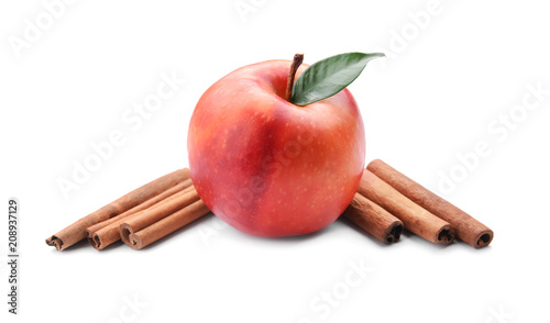 Fresh apple and cinnamon sticks on white background