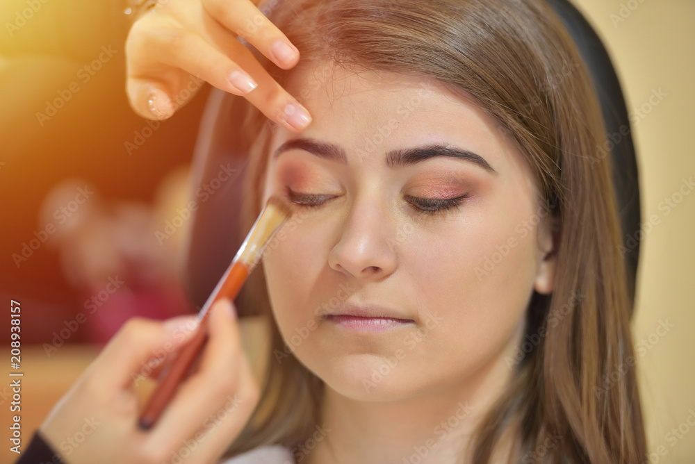 Makeup artist creating beautiful makeup for bride before the wedding Makeup artist creating beautiful makeup for bride before the wedding