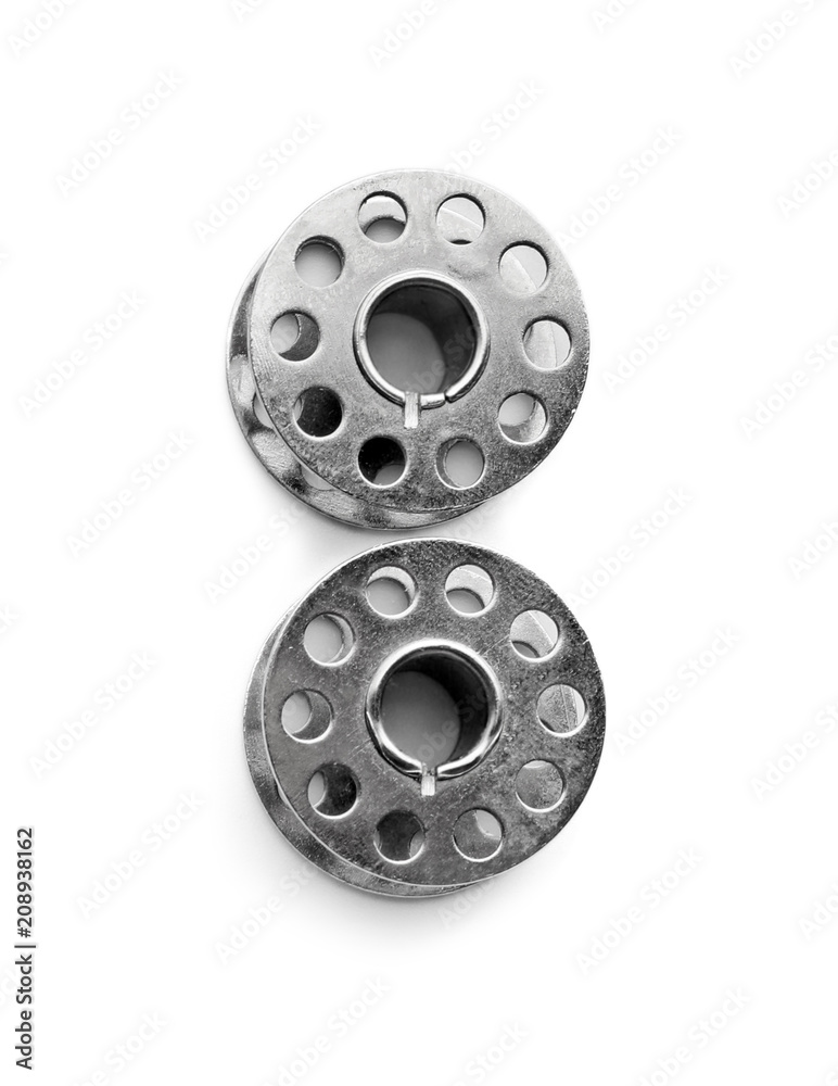 Obraz premium Metal spools for thread on white background