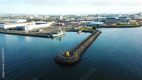 drone approaching the lighthouse and port with ships Reykjavik Iceland. Aerial drone video photo