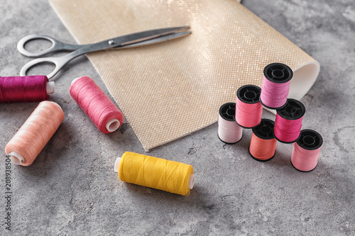 Photos Sewing accessories on grey background