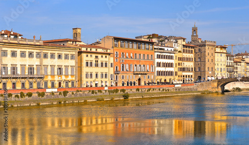colorful buildings and water reflections on river in florence  italy