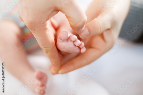 Father or mother holding foot of newborn baby