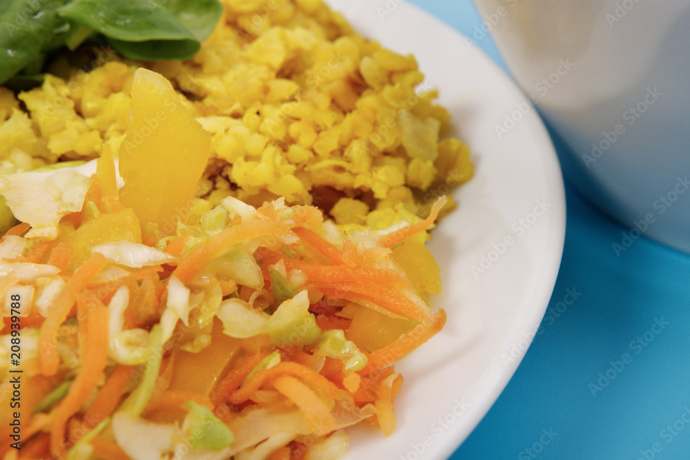 Baked Bulgar with cauliflower and vegetable salad on a blue