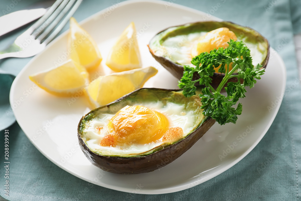 Baked avocado with eggs on table Baked avocado with eggs on table