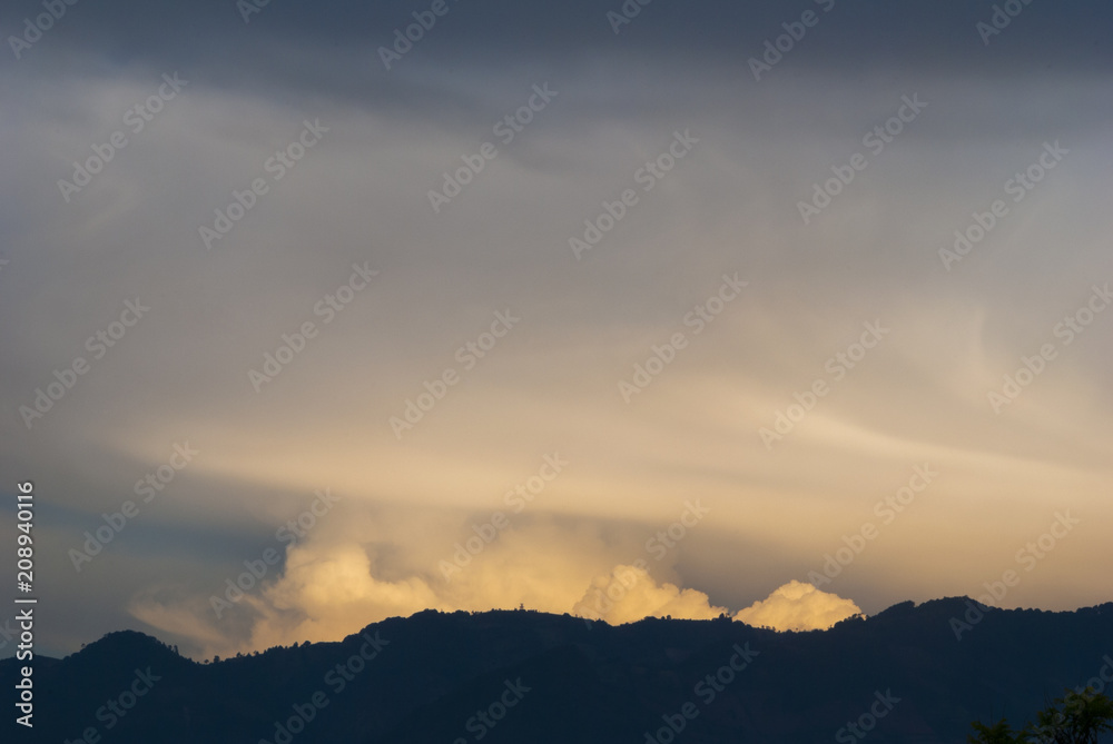 Cumulonimbus in dramatic sunset and mountain silhouette in central america, Guatemala.