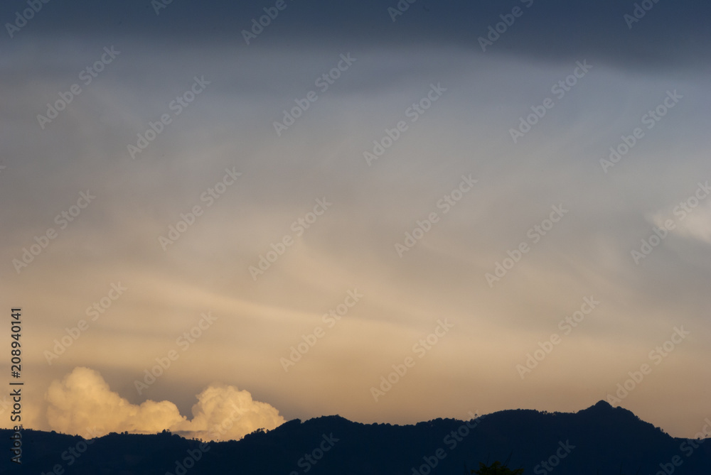 Cumulonimbus in dramatic sunset and mountain silhouette in central america, Guatemala.