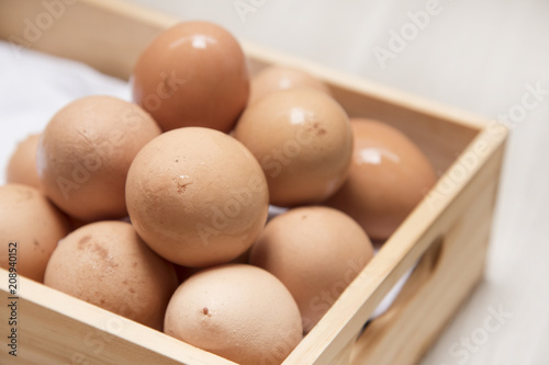 Many eggs are on wooden boxes.