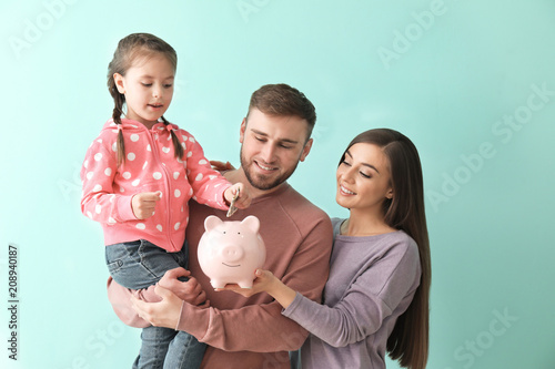 Happy young family with pig...