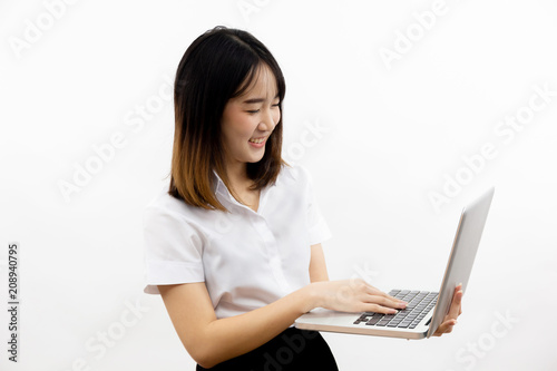 Smiling happy and cheerful Asian female formal dress holding a laptop notebook isolated over white background.