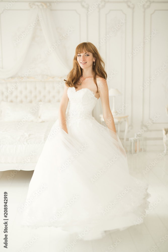 Portrait of beautiful bride with fashion veil at wedding morning