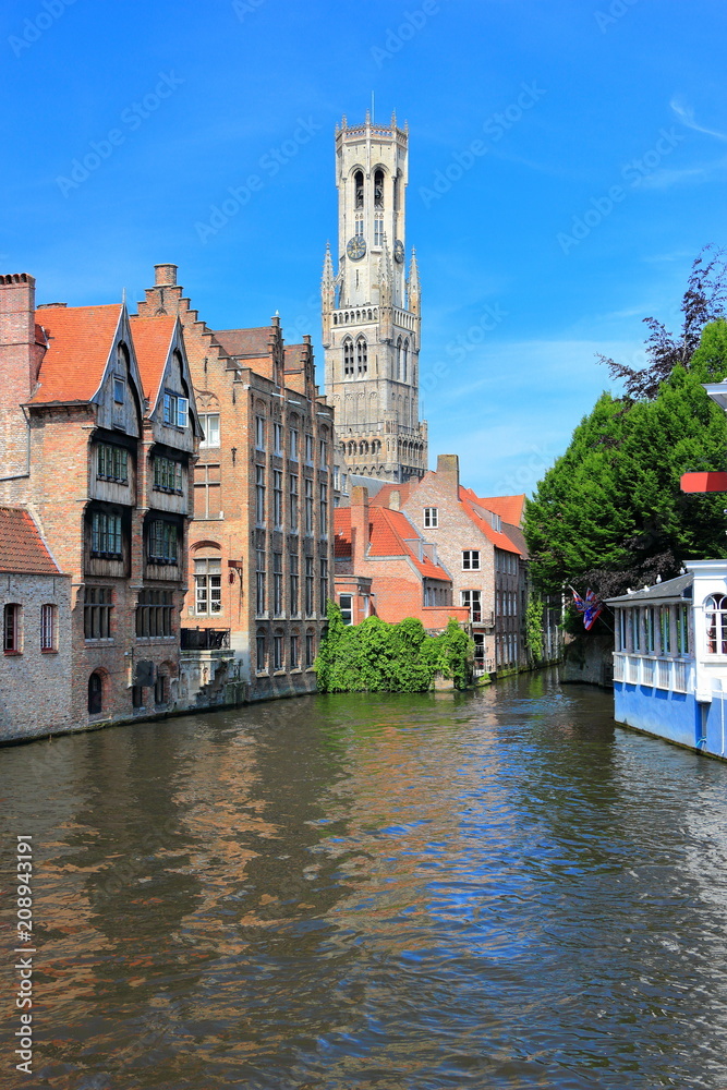 The Rozenhoedkaai (canal) in Bruges with the belfry in the background. Belgium, Europe.