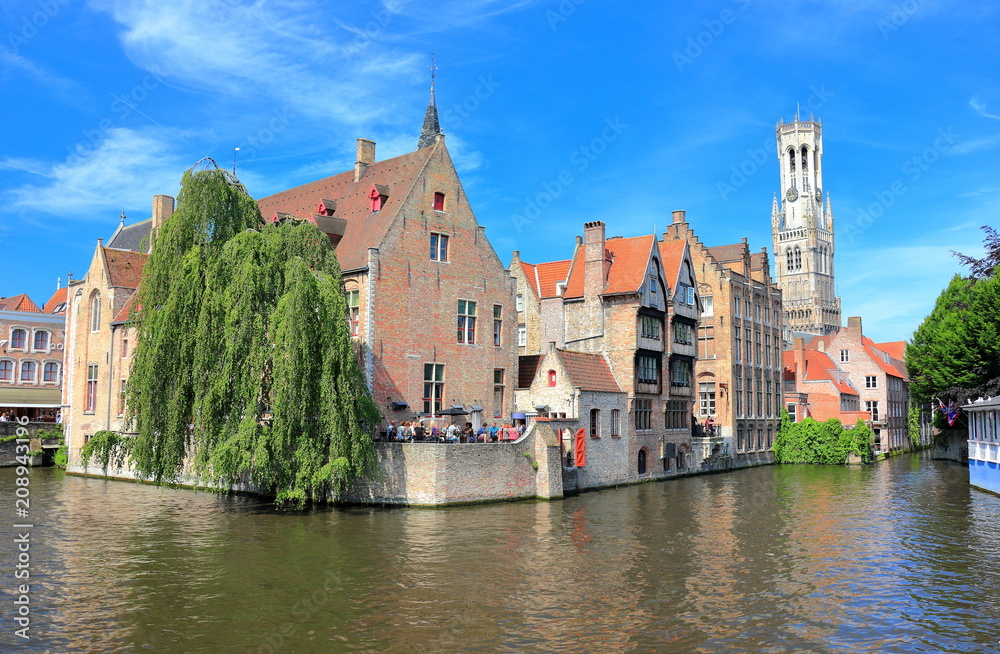 The Rozenhoedkaai (canal) in Bruges with the belfry in the background. Belgium, Europe.