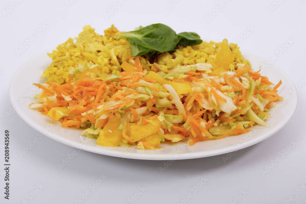 Baked Bulgar with cauliflower and vegetable salad on a white Baked Bulgar with cauliflower and vegetable salad on a white