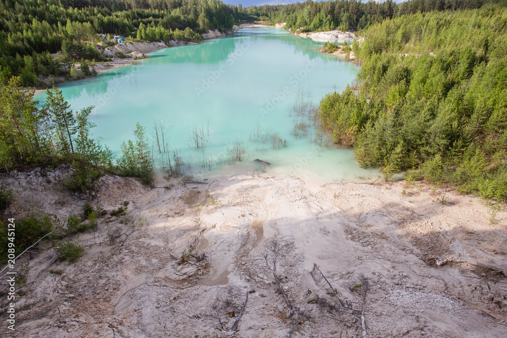 Obraz premium Flooded open pit quarry ore kaoline mining with blue water