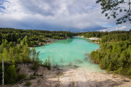 Flooded open pit quarry ore kaoline mining with blue water