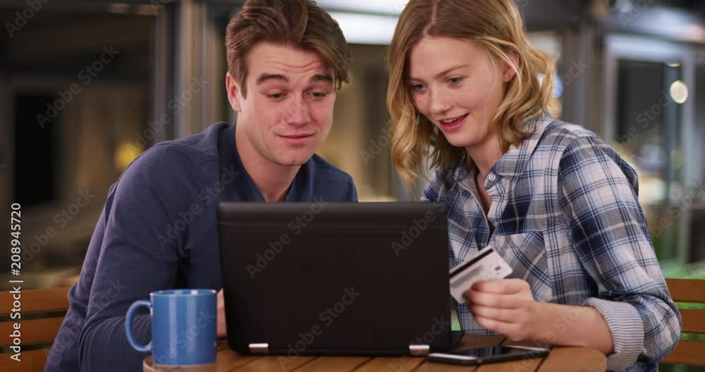 Attractive young couple shopping online with computer, Caucasian man and woman make online purchase with credit card, 4k Attractive young couple shopping online with computer, Caucasian man and woman make online purchase with credit card, 4k