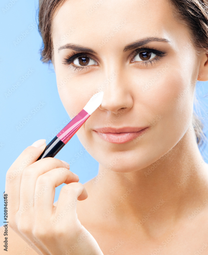 Woman with cosmetics brush, on blue Woman with cosmetics brush, on blue