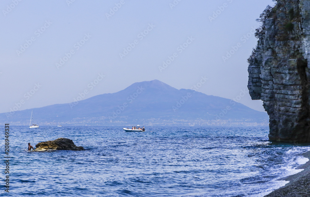 The beach on Amalfi Coast,  the volcano Mount Vesuvius in the background. Vico Equense. Italy
