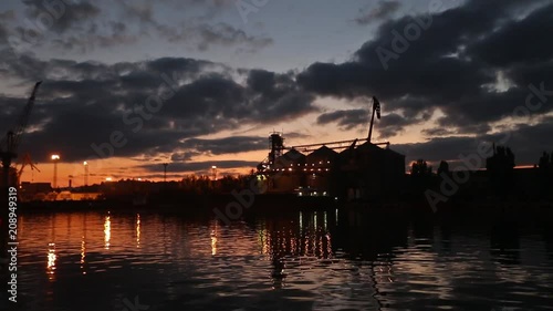 Wallpaper Mural Panorama of big grain terminal at seaport in the evening. Cereals bulk transshipment to vessel at night. Loading grain crops on ship from large elevators at the berth. Selective focus and bokeh Torontodigital.ca