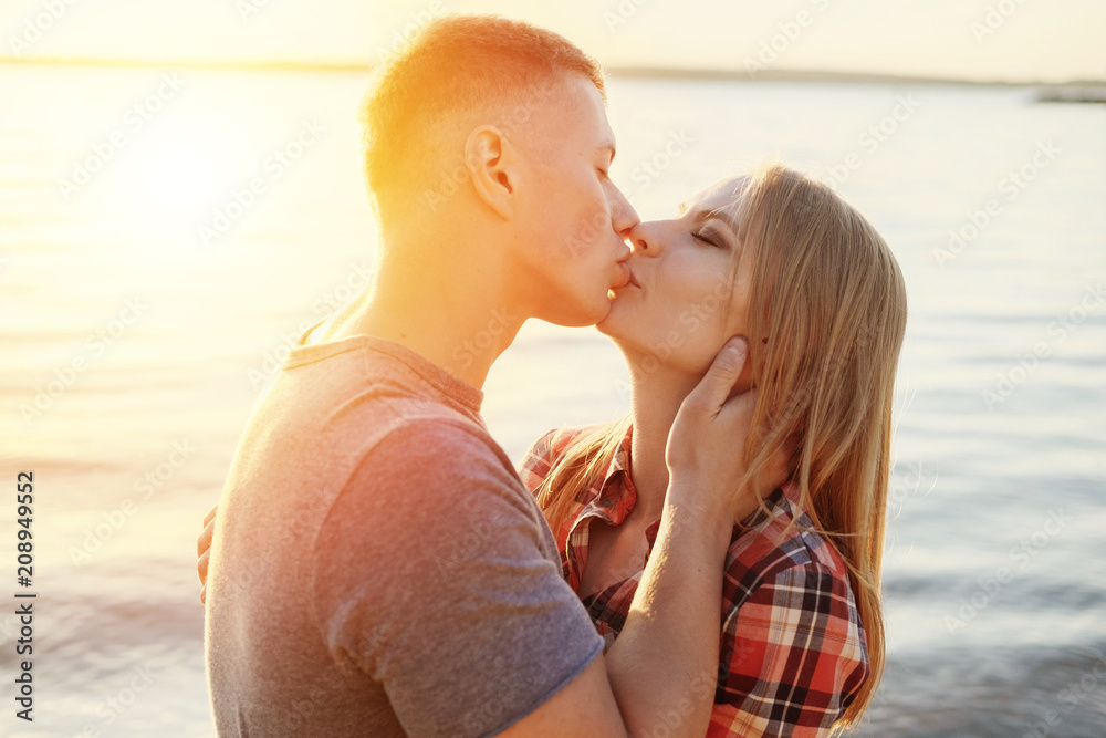 Fototapeta premium couple happy on the beach sunset romantic kiss close-up
