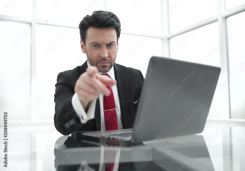 serious Businessman pointing the finger at you,sitting at his Desk serious Businessman pointing the finger at you,sitting at his Desk