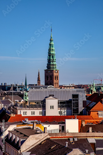 aerial view of old tower with tall spire and cityscape in copenhagen, denmark