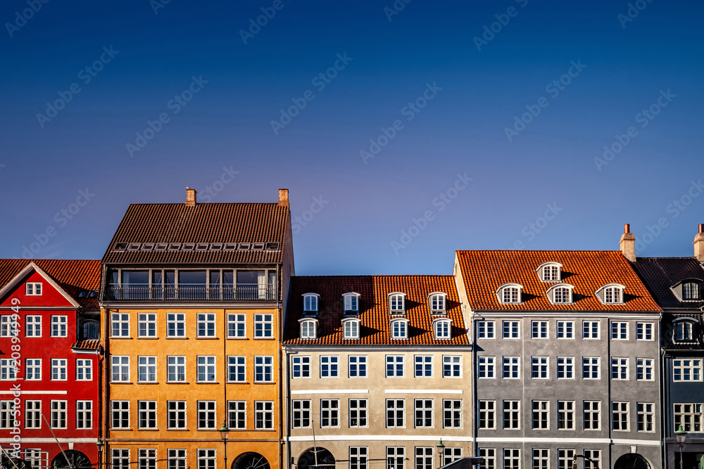 beautiful historical houses against blue sky at sunny day, copenhagen, denmark