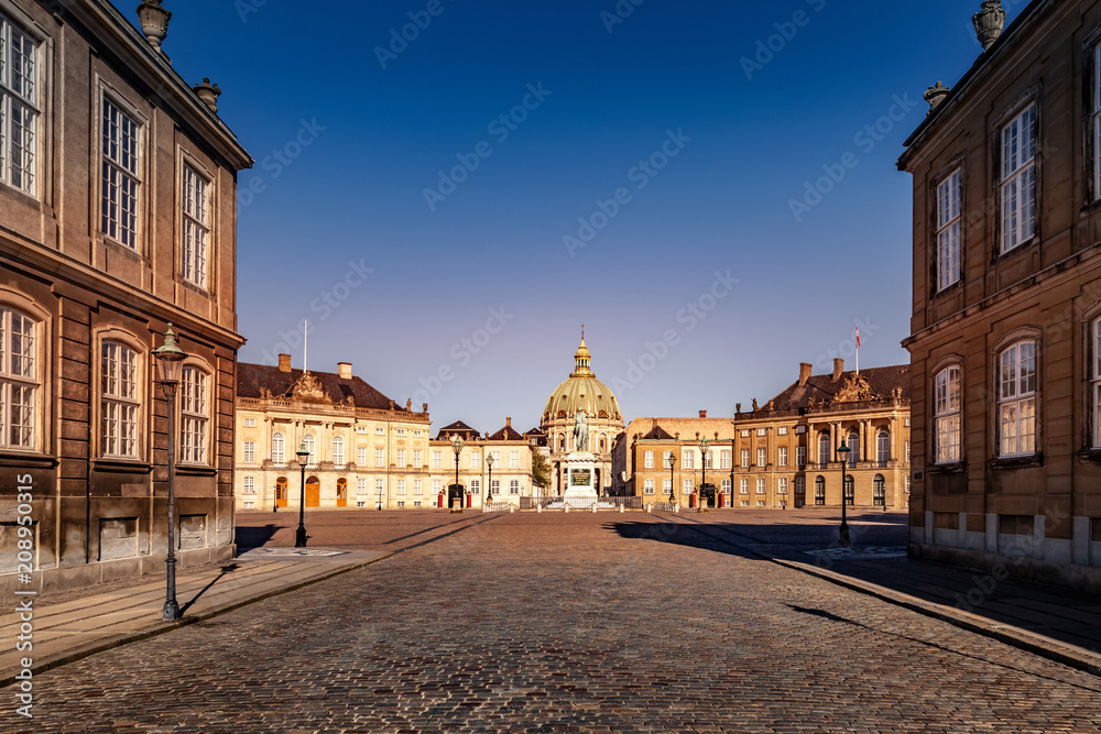 beautiful cityscape with historical buildings and old cathedral on empty square in copenhagen, denmark