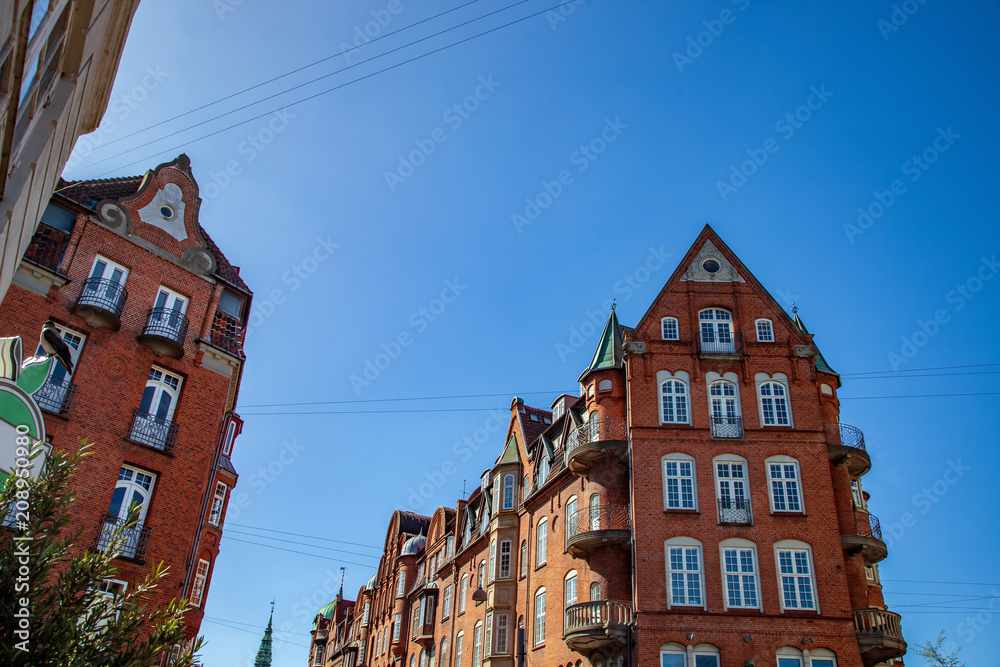 low angle view of buildings against blue sky, copenhagen, denmark