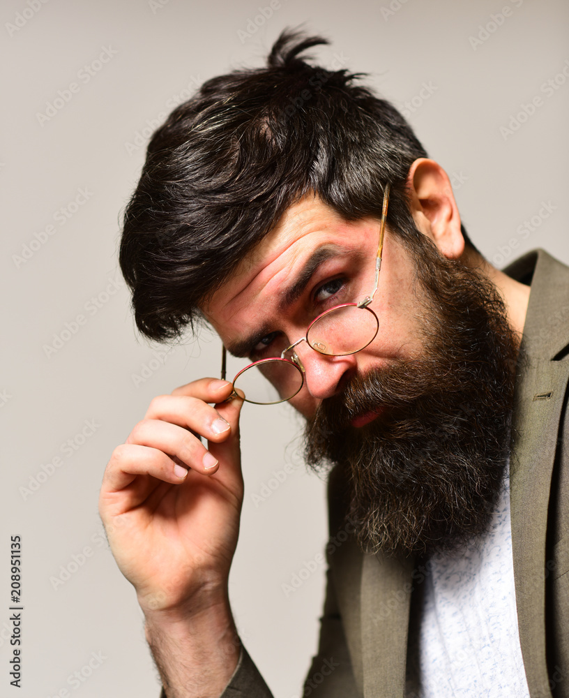 Fashion accessory and business style. Bearded man with stylish hair.  Hipster with long beard and mustache on unshaven face. Businessman in suit.  Man teacher wear glasses with genius look Stock Photo |