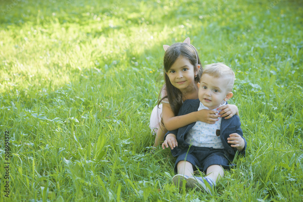 Family, children, brother and sister on green grass Family, children, brother and sister on green grass