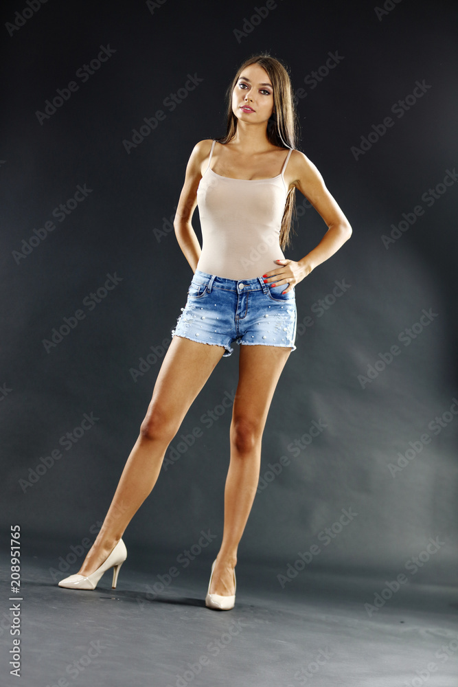 Fototapeta premium slim woman in jeans and dark mood background 