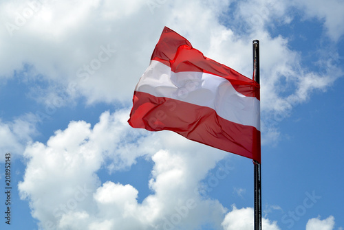 Austrian flag in front of summer sky photo