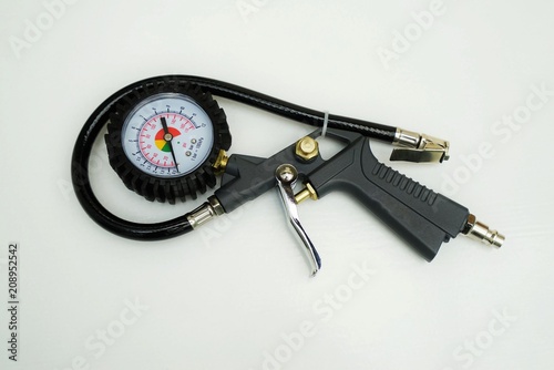 New tire pressure gauge on white background