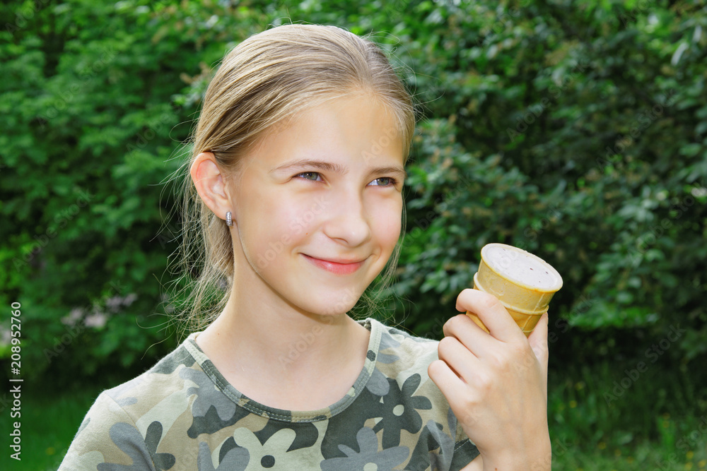 Portrait of a joyful teenage girl with ice cream in her hand