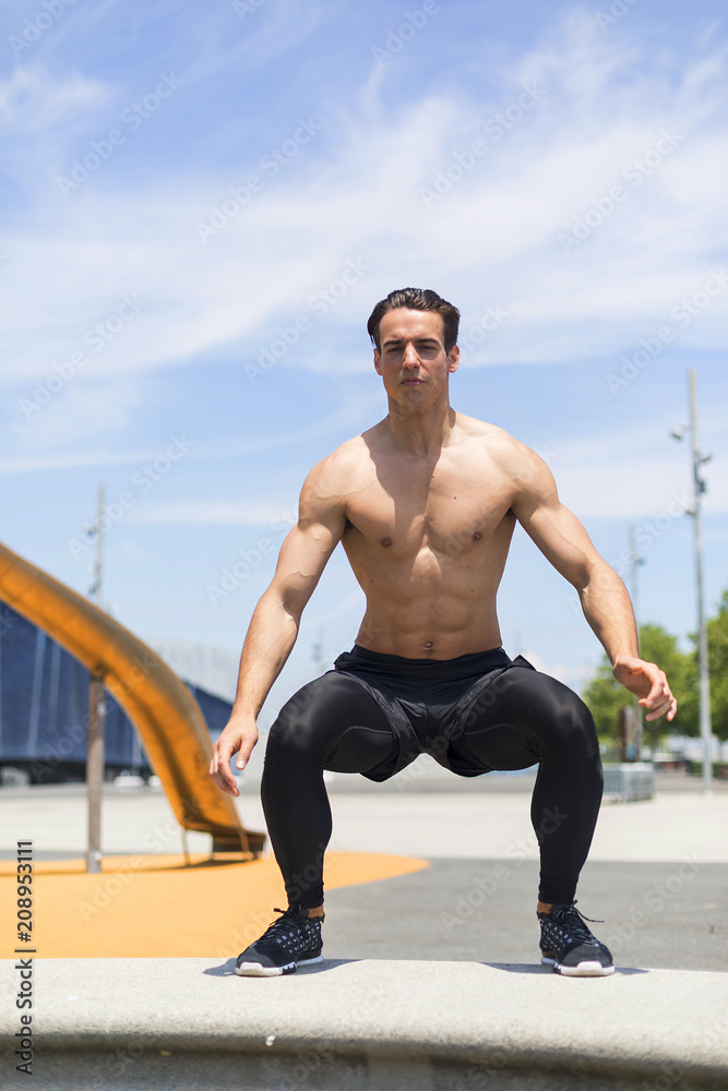 Obraz premium Muscular man doing box jumps outdoors.