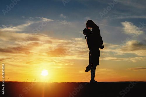 couple happy on the beach sunset romantic kiss silhouette