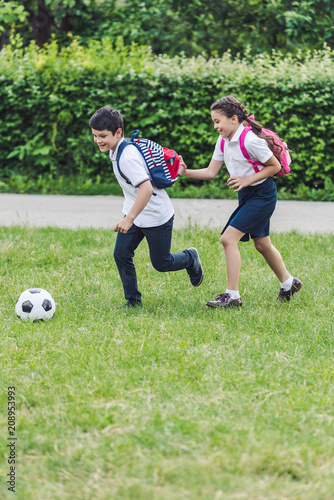 active schoolchildren playing soccer together on meadow in park © LIGHTFIELD STUDIOS