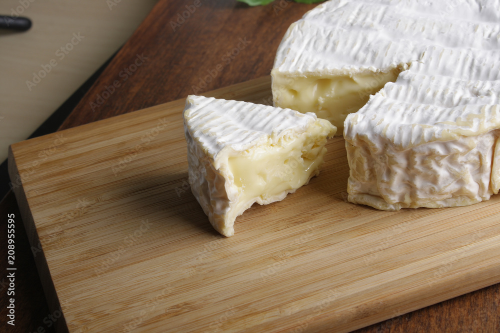 Camembert brie cheese on a wooden background