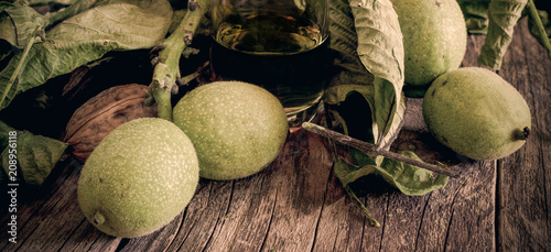 nocino liqueur made with unripe green nuts and alcohol photo