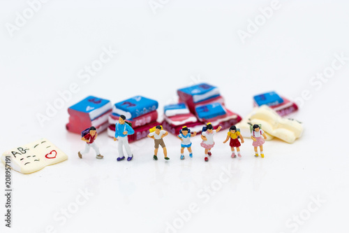 Miniature people: Children's group with teaching equipment. Image use for back to school