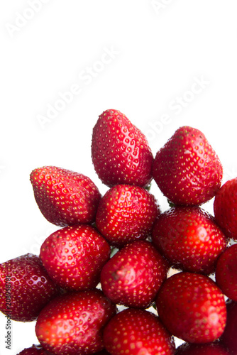 A few healthy red strawberries on a white background