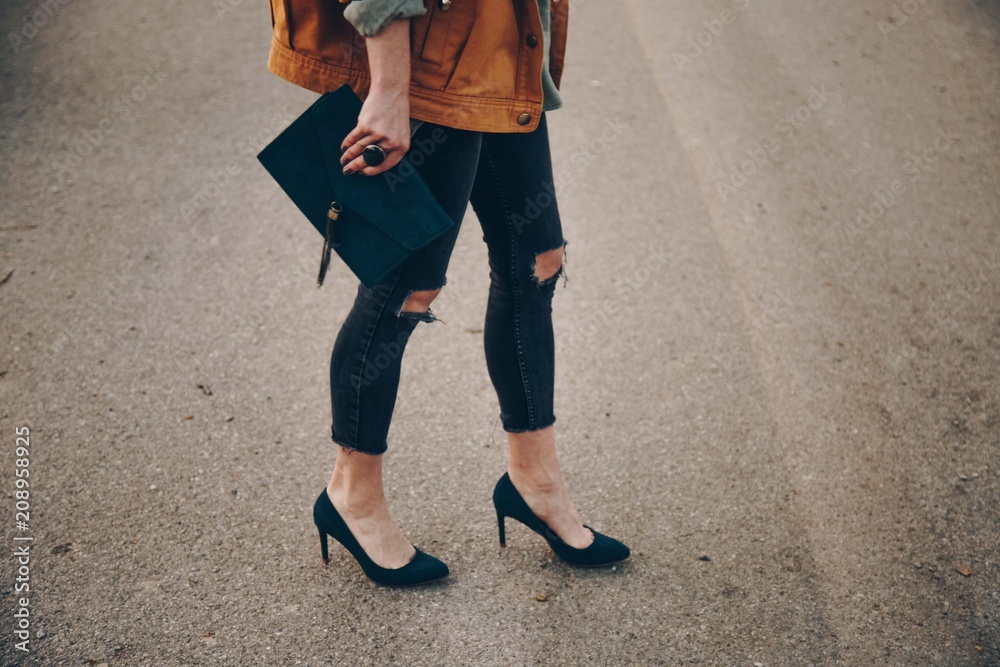 street style fashion details, chic blogger posing in trendy clothes. close up of a elegant handbag, suede leather purse. ideal fall or autumn outfit. 