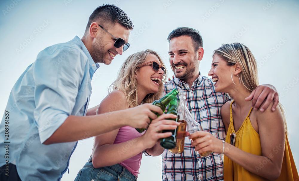 Fototapeta premium It's party time. Group of young people enjoying in party outdoors. Lifestyle, fun concept